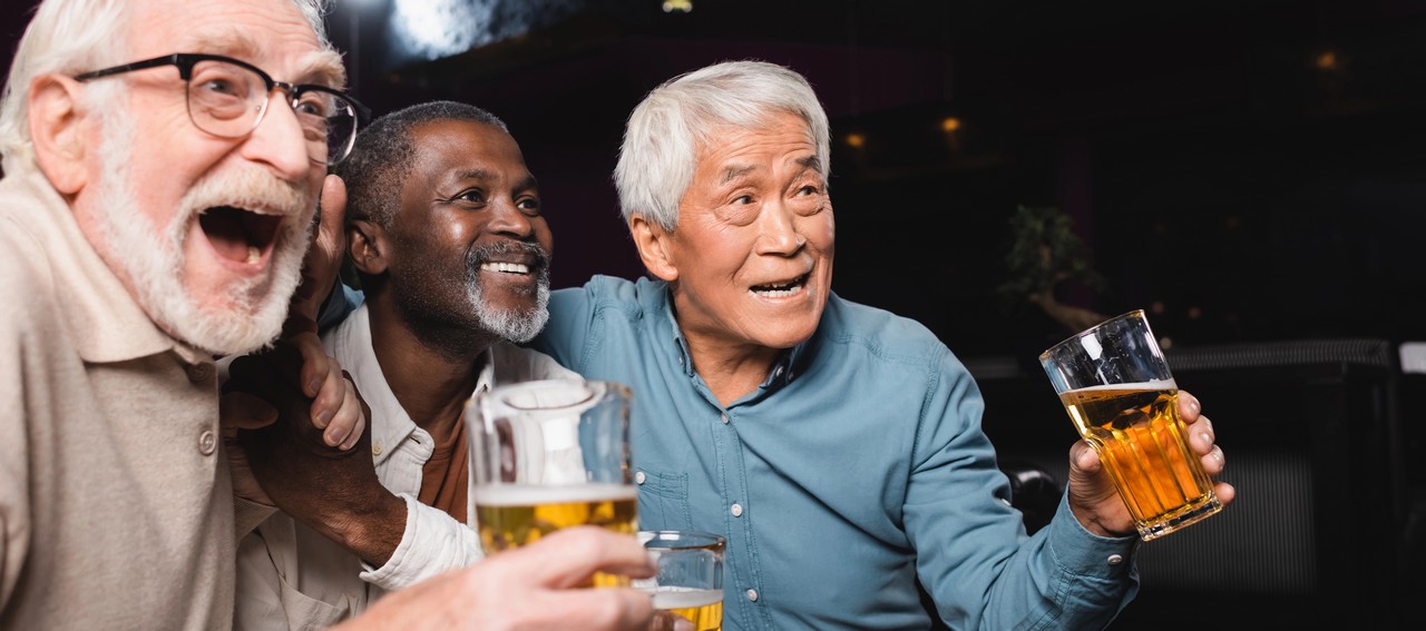 Friends sharing a beer and a laugh at Palmwoods Community Club